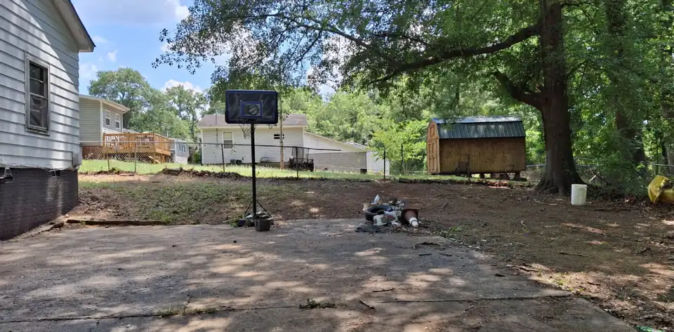 After: A cluttered back yard slab and lawn cleaned up