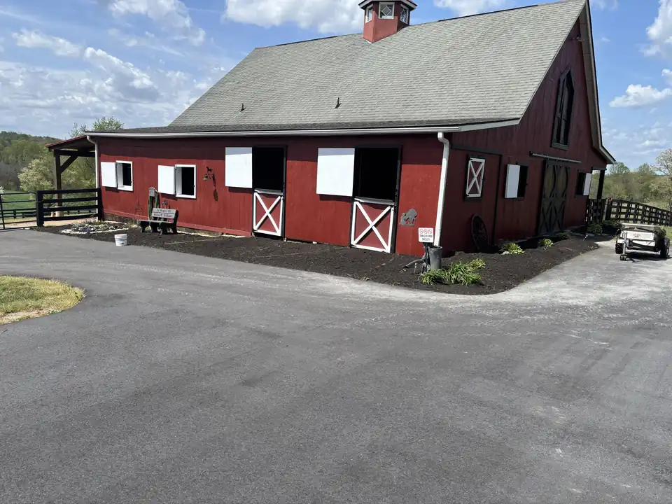 Fresh beds along a red barn