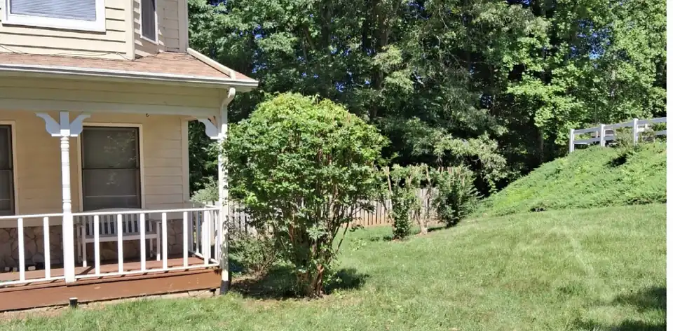 After: An overgrown shrub by a porch cut back to shape