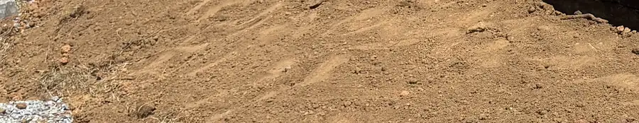 Graded red clay after digging down to firm ground