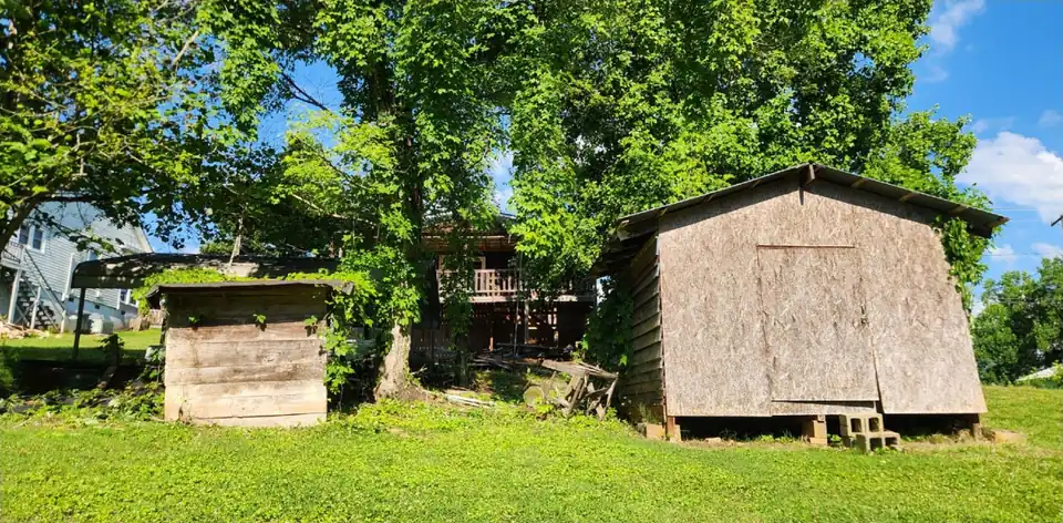 After: Vines and brush cleared from around two old sheds