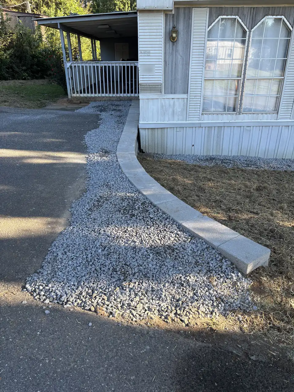 Low block wall stopping a driveway washout